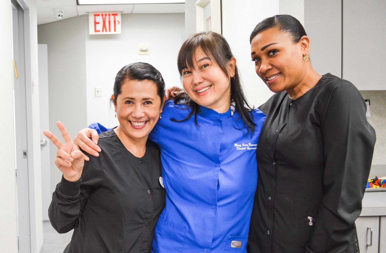 photo showing three assistants smiling